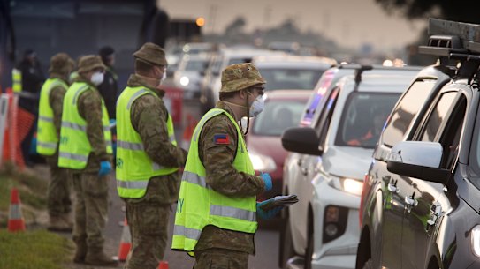 Soldiers and Victoria police on a roadside checkpoint on the Geelong Freeway enforcing lockdown in Melbourne on Friday.