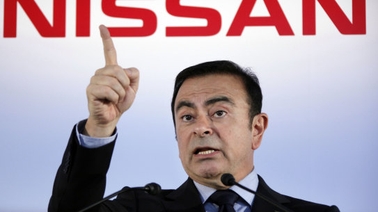 Then Nissan president and CEO Carlos Ghosn speak during a press conference in Yokohama, near Tokyo, in 2012.  