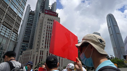 Pro-China supporters hold a placard on their way to protest at the US Consulate in Hong Kong on Sunday, May 31.