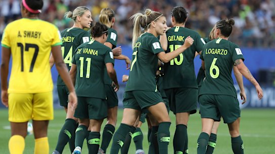 Australia's Sam Kerr is congratulated by her teammates after scores her side's opening goal.