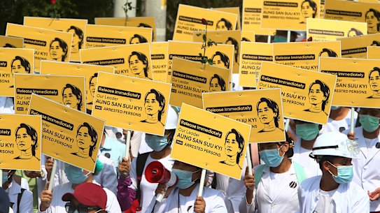 Medicals students display images of deposed Myanmar leader Aung San Suu Kyi during a street march in Mandalay, Myanmar.