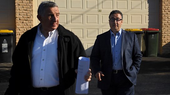 Shaoquett Moselmane, right, with his lawyer as he leaves his home on Lennox street in Rockdale during a raid by federal agents.