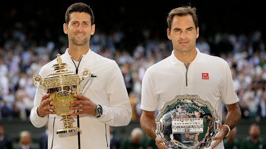 Novak Djokovic and Roger Federer  with the trophies after the Serb’s win in the 2019 Wimbledon final.