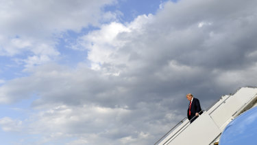 US President Donald Trump walks down the steps of Air Force One.