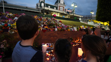 Mourners attend a candlelight vigil outside Dreamworld on October 28, 2016.
