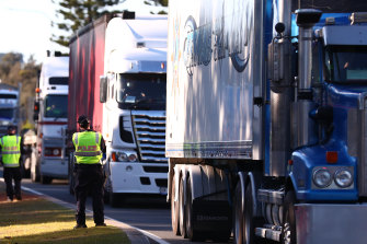 Trucks stop at the Queensland border in Coolangatta.