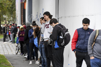 International students and Melburnians impacted by the COVID-19 shutdown line up for food assistance.