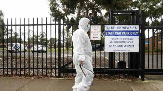 Cleaning crews at Keilor Views Primary School in Melbourne's west on Tuesday morning, where a student has tested positive for coronavirus.