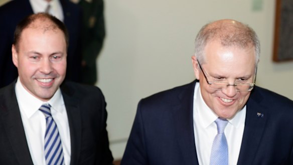 Scott Morrison and Josh Frydenberg emerge from the party room on Friday. 