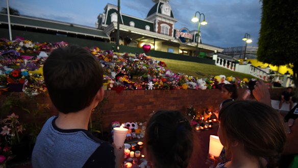 Mourners attend a candlelight vigil outside Dreamworld on October 28, 2016.