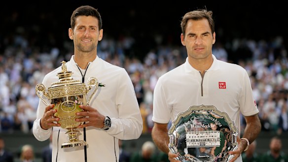Novak Djokovic and Roger Federer  with the trophies after the Serb’s win in the 2019 Wimbledon final.