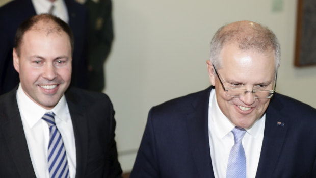 Scott Morrison and Josh Frydenberg emerge from the party room on Friday. 