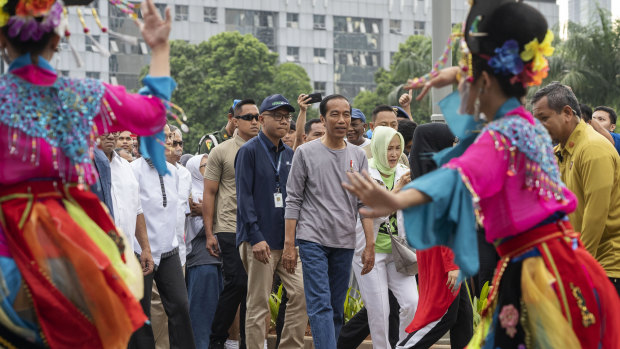 On track for re-election: President Joko Widodo arrives for the opening of Jakarta's first mass-transit system.