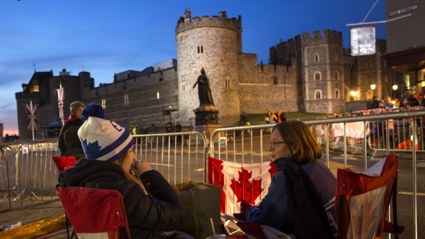 A group of woman from Canada sit outside Windsor Castle, England, on Thursday.