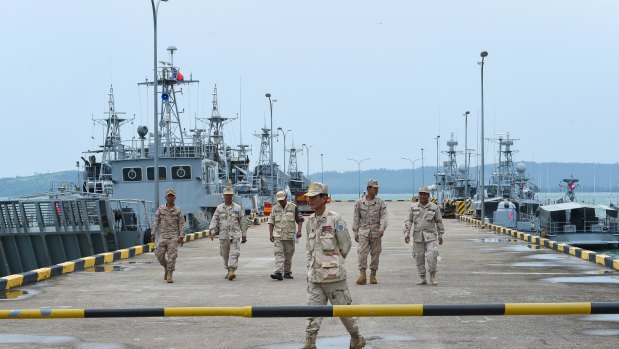 Navy personnel walk on a jetty at the Ream Naval Base in Cambodia during a government-organised media tour last year.