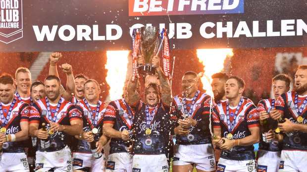 Jake Friend lifts the World Club Challenge trophy at Totally Wicked Stadium in St Helens.