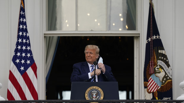 Donald Trump removes his mask to speak. 