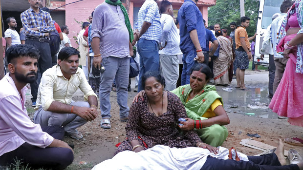 Women mourn next to the body of a relative outside the Sikandrarao hospital in Hathras district about 350 kilometres southwest of Lucknow, India.