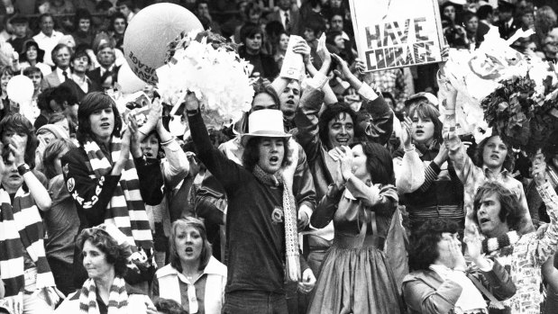 North Melbourne fans cheer their side in the '75 decider.