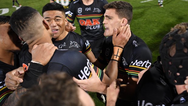 Nathan Cleary, right, celebrates with Panthers teammates after the win over the Sharks.