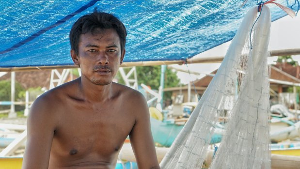 Oli, a fisherman from Kedonganan fishing village on his fishing boat. 