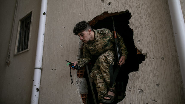 A fighter of the UN-recognised government of national accord exits a building in Salah al-Din frontline in Tripoli last week.