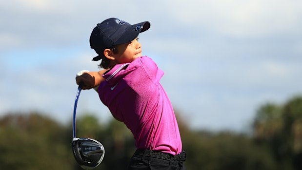 Charlie Woods hits his tee shot on the fifth hole.