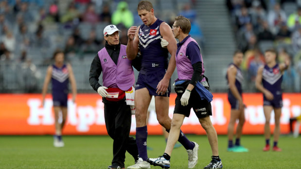 Aaron Sandilands leaves the field after his head clash.