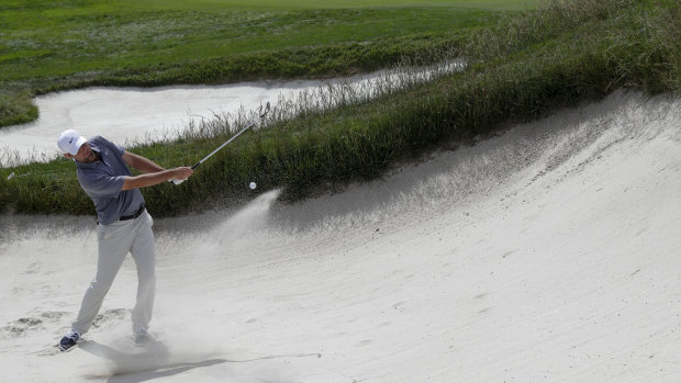 Brooks Koepka hits out of a bunker during a practice round.