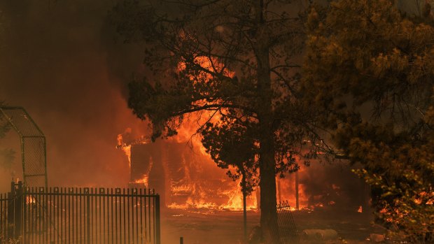 A house on fire that could not be saved in the fires on the outskirts of Bargo, NSW on Thursday.
