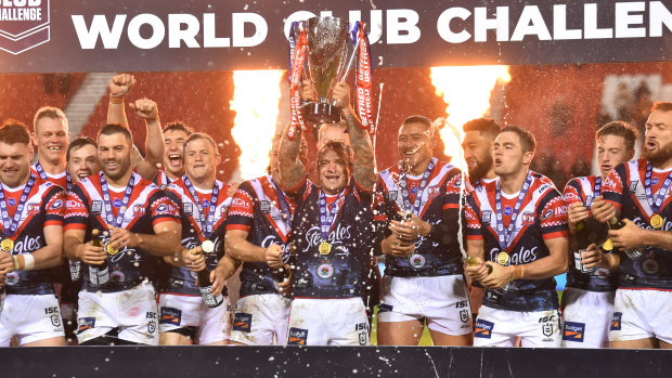 Jake Friend lifts the World Club Challenge trophy at Totally Wicked Stadium in St Helens.