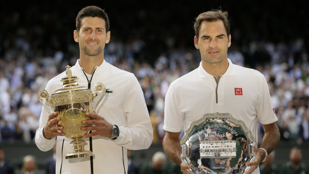 Novak Djokovic and Roger Federer  with the trophies after the Serb’s win in the 2019 Wimbledon final.