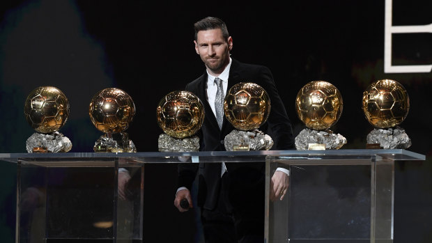 World's best: Lionel Messi poses onstage after winning his sixth Ballon D'Or on Monday.