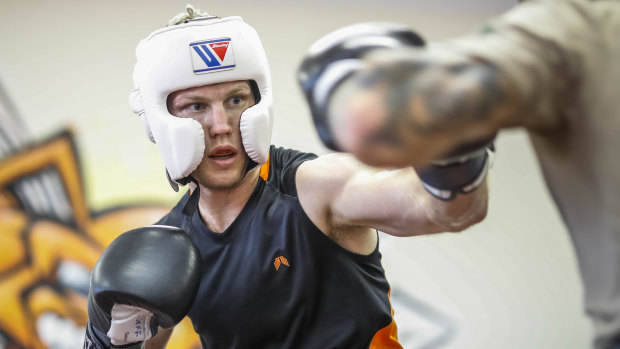 Jeff Horn spars with his new lightweight gloves at his training base in Brisbane on Thursday.