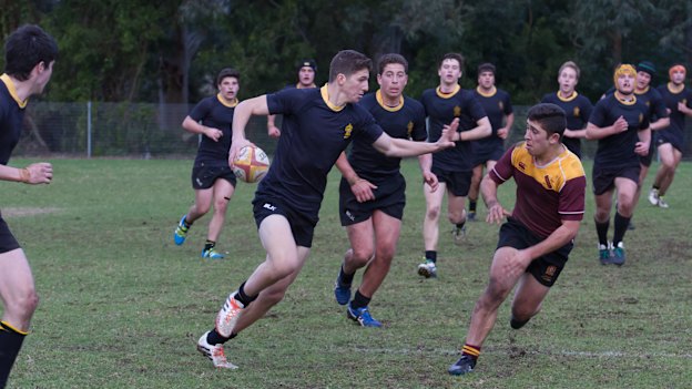 A 14-year-old Nawaqanitawase supports Adam Doueihi while playing for St Patrick’s College Strathfield’s first XV in 2016.
