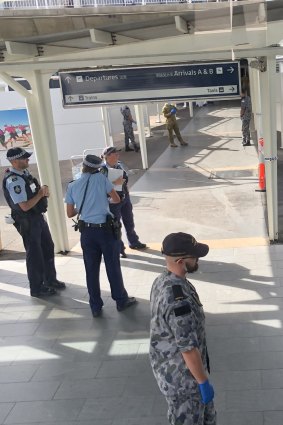 Australian Defence Force personnel escorted Ellie Chen and other passengers onto a bus in Sydney. 