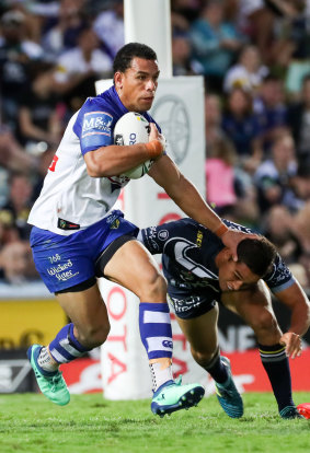 Verve: Will Hopoate palms off Te Maire Martin as he looks to start an attack from deep in the Bulldogs' half.