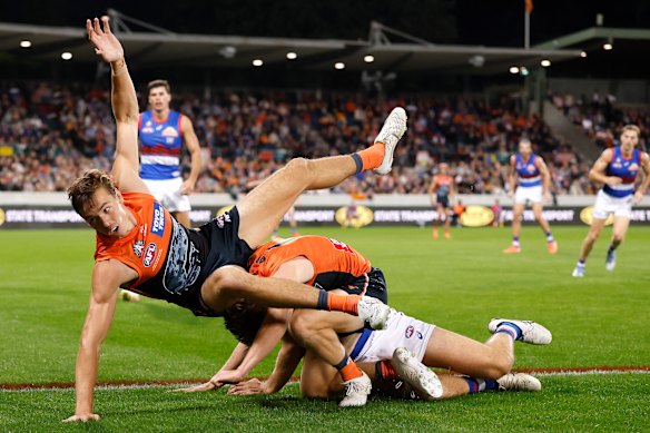 Aaron Cadman of the Giants tumbles over a pack.