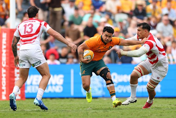 Hunter Paisami runs the ball in Townsville against Japan.