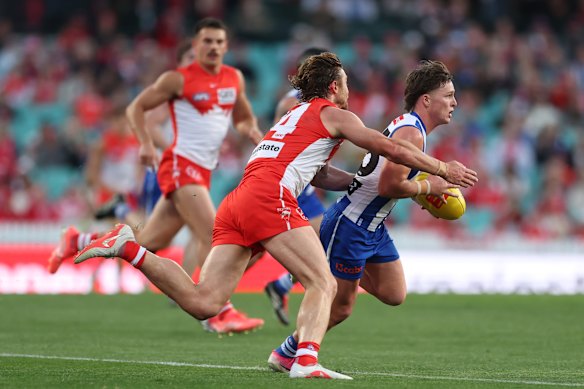 Dane Rampe of the Swans tackles Zac Banch of North Melbourne.