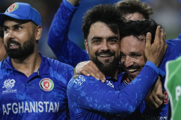 Afghanistan’s captain Rashid Khan embraces teammate Gulbadin Naib after beating Bangladesh.