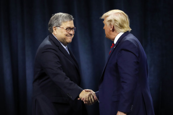 US President Donald Trump shakes hands with Attorney-General William Barr.