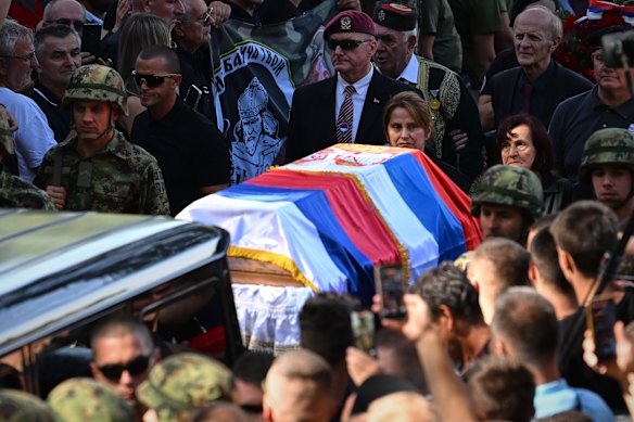 Serbian national military servicemen walk by Mladić’s coffin at the Topcider Cemetery.