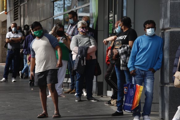 People lining up for a COVID vaccination. The pandemic, and its impact on the overall economy, remains the Reserve Bank’s focus.