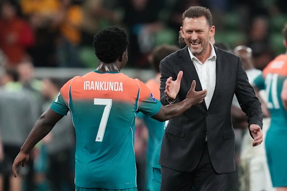 Nestory Irankunda with Australia’s coach Tony Popovic.