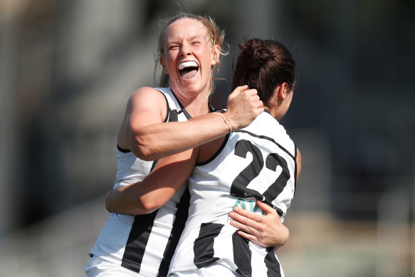 Sarah D'Arcy and Sophie Casey celebrate a goal en route to Collingwood's first ever AFLW win over the Pies.