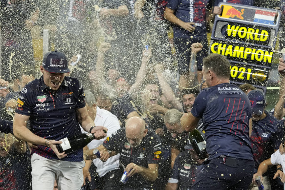 Red Bull’s Max Verstappen (left) celebrates with team chief Christian Horner and his crew after the victory.