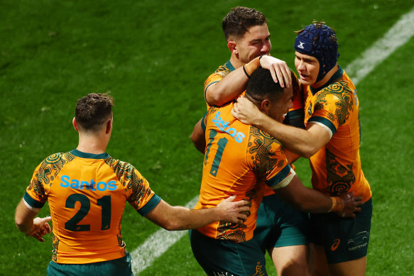 Filipo Daugunu of the Wallabies (C) celebrates scoring a try