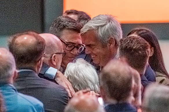 Burnham embraces his mother, Eileen, and brother, John, after delivering his speech.