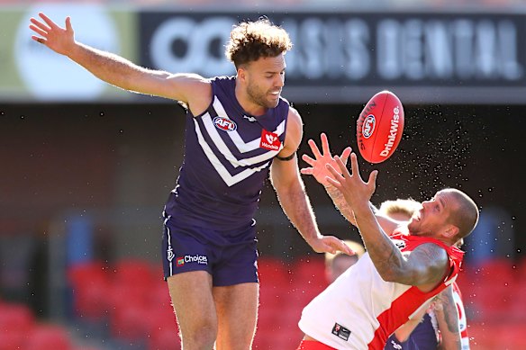 Lance Franklin of the Swans marks the ball.